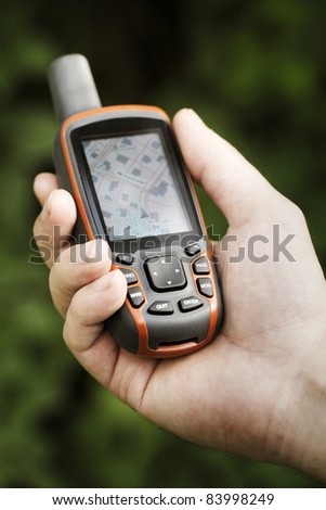 Man holding a GPS receiver in his hand. Handheld GPS devices are used predominantly in the outdoor leisure industry for walking and hiking.