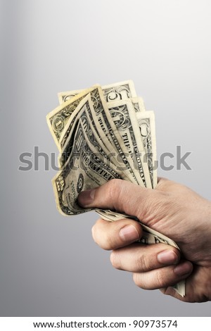 Man holding old US dollars in his hand.
