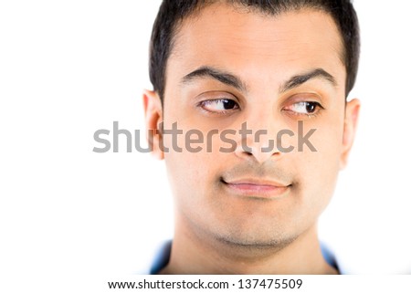 Cropped image a man\'s face with his eyes looking at side against white background