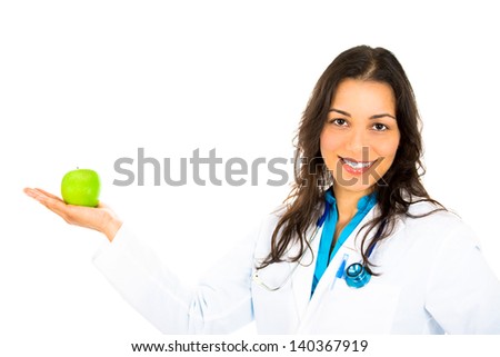 Confident female doctor with apple in hand.  An apple a day keeps the doctor away.