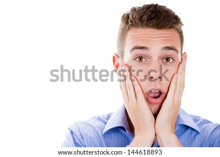 Closeup portrait of a young handsome guy surprised, shocked, scared, with hands on cheeks, isolated on white background