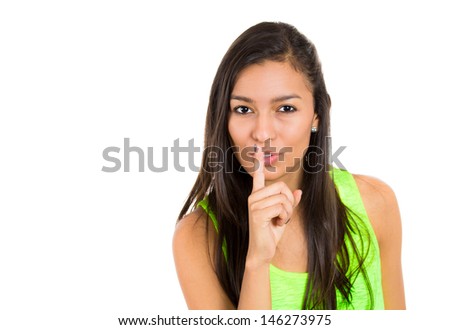 Closeup of serious woman placing finger on lips, pointing at you as if to say, shhhhh, quiet, silence , isolated on white background. Human face expressions, signs, emotions, feelings, body language