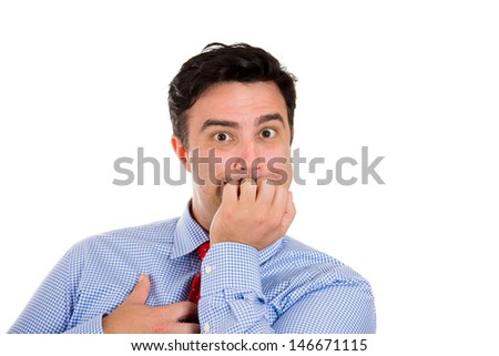 Closeup portrait of scared, worried, anxious businessman biting nails, fingers in mouth, clutching chest in fear, isolated on white background with copy space