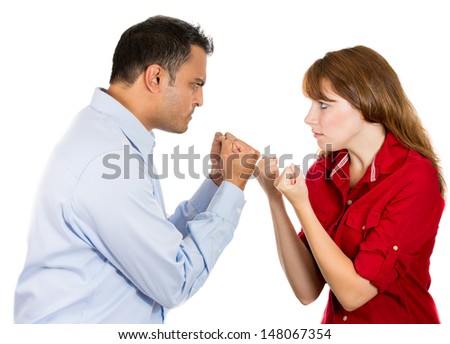 Closeup portrait of a stressed, arguing couple going through hard times in their relationship, boxing face to face isolated on a white background.
