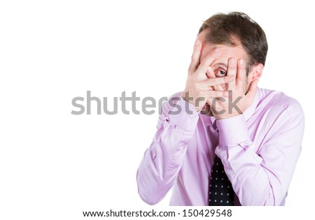 Closeup portrait of scared man covering face with one eye open, isolated on white background with copy space