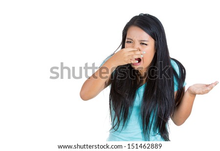 Closeup portrait young woman, disgust on face, pinches nose looks funny, something stinks, very bad smell, situation, isolated white background. Negative emotion, facial expression, feeling reaction
