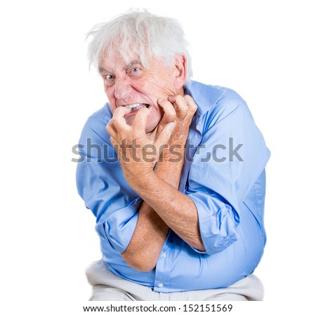 A close-up portrait of an elderly, desperate, mad, crazy looking man, biting his nails, isolated on a white background. Extremes of human emotions. Family loss, elderly loneliness.Geriatric problem