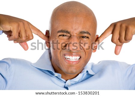 Closeup portrait of handsome man with blue shirt and covering his ears, headache from loud noise, isolated on white background