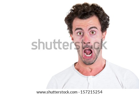 Closeup portrait of a shocked, surprised, astonished young guy, isolated on white background with copy space. Human emotions and facial expressions