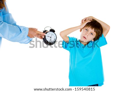 Closeup portrait of mom showing kid clock that it is time to go to bed. He doesn't like that. Isolated on white background