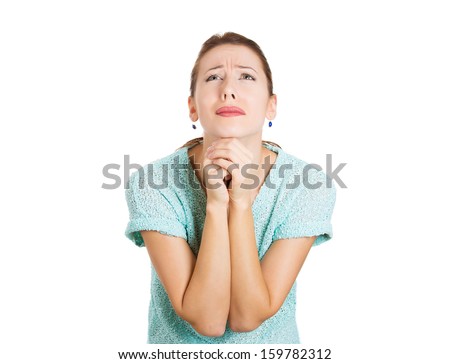 Closeup portrait of a sad young woman praying, hoping, begging for the best, going through tough times i her life, isolated on white background with copy space. Human emotions and facial expressions.