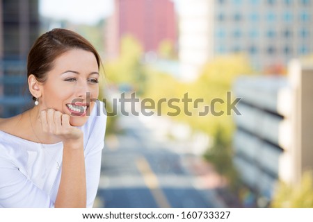 Closeup portrait of beautiful, happy, relaxed woman enjoying a weekend on sunny day, on balcony of her apartment isolated on city background. Urban life style of businesswoman, corporate professional.