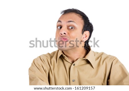 Closeup portrait of crazy man in brown shirt making wacky faces in neurotic nervous manner, isolated on white background with copy space. Negative emotions and facial expressions