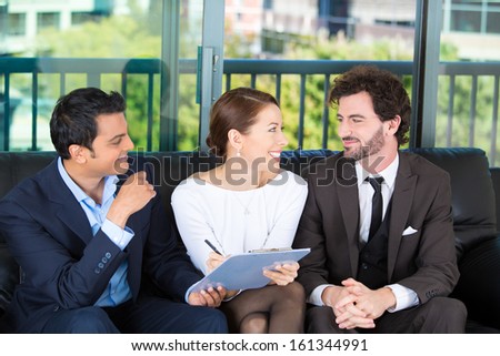 Young happy, smiling couple sitting on sofa with legal financial adviser, broker, ready to sign a document . House mortgage refinance. Financial decisions. Investment opportunities. Brokerage account.