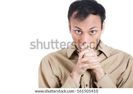 Closeup portrait of young man looking at you, thinking fast about how to escape unpleasant situation, after being insulted, trying to restrain himself from firing back, isolated on white background