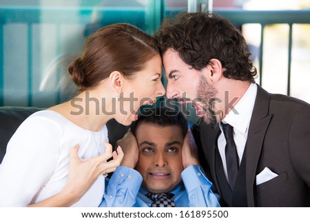 Closeup Portrait Of Man Lawyer Or Counselor Caught In Between Fighting Yelling Screaming Couple On Black Couch Office, Trying To Close Ears Because They Are So Loud, Isolated On City Urban Background.