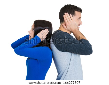 Closeup portrait of couple, man woman standing with backs together, covering ears, opened eyes, not listening to each other isolated on white background. Negative human emotions facial expressions