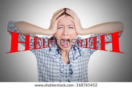 Closeup portrait of stressed, overwhelmed screaming young woman, student, worker, squeezing head with hands, isolated on grey background. Negative human emotions, face expressions, feelings, reaction.