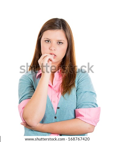 Closeup portrait of young woman with finger in mouth, sucking thumb or biting fingernail in anxiety, stress, or bored, clueless about situation, isolated on white background. Human face expression