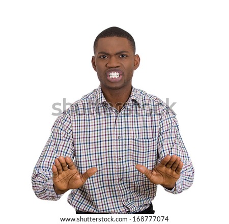 Closeup portrait of handsome shocked mad young man raising hands up to say no stop right there, isolated on white background. Negative human emotion facial expression feelings, signs and symbol