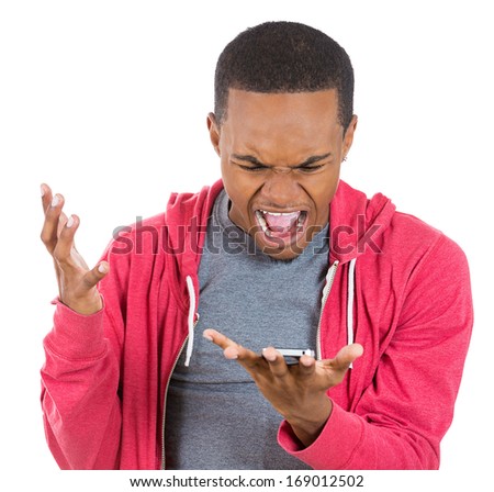 Closeup portrait of handsome young man shocked surprised, open mouth and eyes, mad by what he sees on his cell phone, isolated on white background. Negative human emotion facial expression feeling