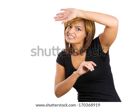 Closeup portrait of young woman looking shocked, scared trying to protect herself in anticipation of an unpleasant situation, isolated on a white background. Negative emotion facial expression feeling
