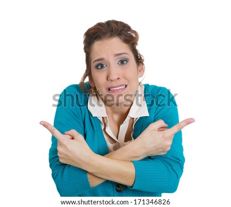 Closeup portrait of confused young woman pointing in two different directions not sure which way to go in life, isolate on white background. Negative emotion facial expression feelings, body language