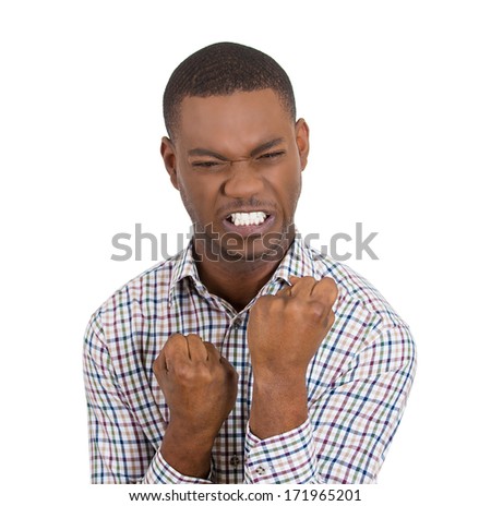 Closeup portrait of angry, mad, furious man raising clenched hand fists in the air, isolated on white background. Negative emotion facial expression feelings, body language, signs and symbols