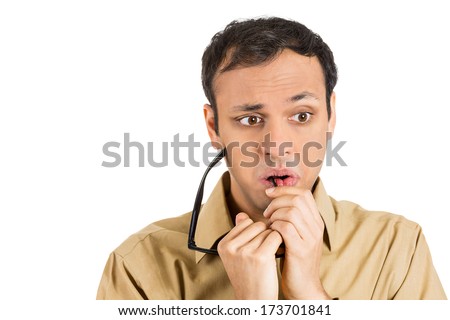 Closeup portrait young stressed man, anxious student, upset worker, nervous teacher, glasses in mouth, looking completely lost, confused, isolated on white background. Negative emotions, expressions