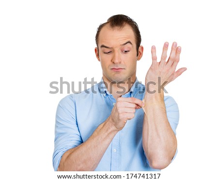 Closeup portrait of young man in blue shirt pinching his skin, giving a reality check gesture, is this a dream, isolated on white background. Positive emotion facial expression feelings, body language
