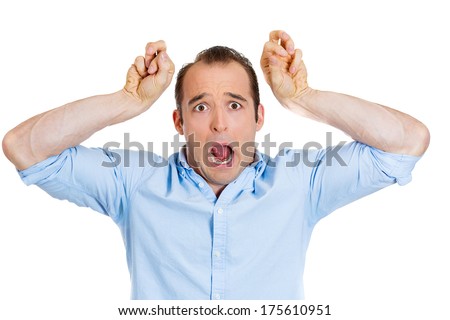 Closeup portrait of stressed young man placing fists on head open mouth and eyes, surprised dumbfounded, isolated on white background. Negative emotion facial expression feelings, body language