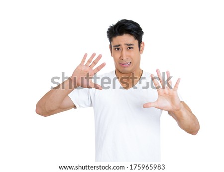 Closeup portrait of scared helpless petrified young man raising hand up to say no stop right there, isolated white background. Negative emotion facial expression feelings, signs symbols, body language
