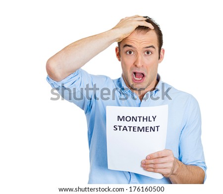 Closeup portrait of sad, shocked funny looking young man disgusted at his monthly statement, isolated on white background. Negative human emotion facial expression feelings. Financial crisis, bad news