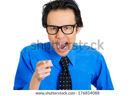 Closeup portrait of angry upset, mad nerdy young man, frustrated business worker employee, pointing at you yelling loud, isolated on white background. Negative human emotion facial expression feelings