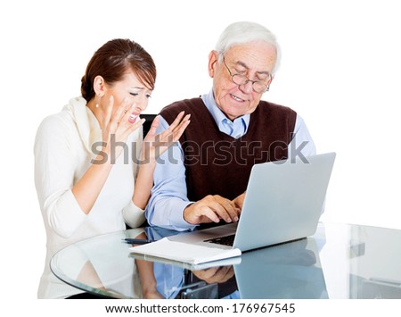 Closeup portrait of young technology savvy, frustrated woman showing confused senior older elderly man with eyeglasses how use laptop isolated on white background. Generation gap difference concept.