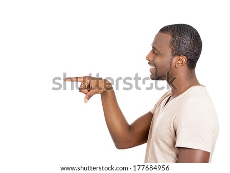 Closeup side view profile portrait of young business man laughing, pointing with finger at someone isolated on white background. Positive human face expression, emotions, feelings,  approach, reaction