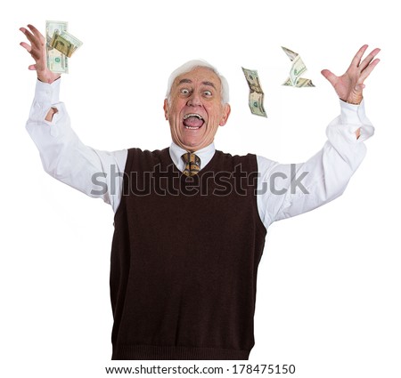Closeup portrait of super excited senior mature man who just won lots of money, trying to catch or throw dollar bills in air, isolated on white background. Positive emotion facial expression feelings.