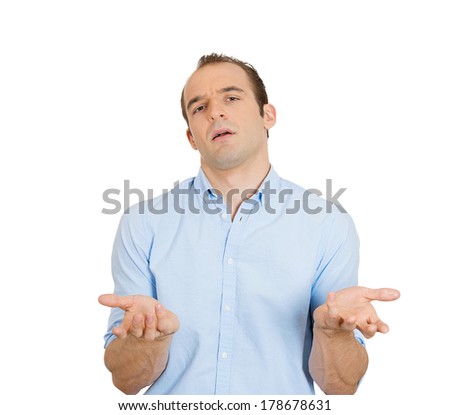 Closeup portrait of dumb clueless funny looking young man, arms out asking what\'s the problem who cares so what, I don\'t know, isolated on white background. Negative human emotions, facial expressions