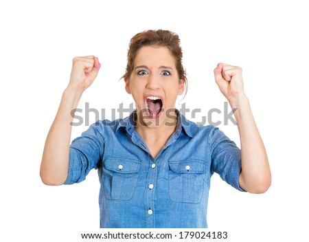 Closeup portrait of angry upset young mad woman, worker, business employee, in blue shirt with fists up at you, isolated on white background. Negative human emotion facial expression feelings