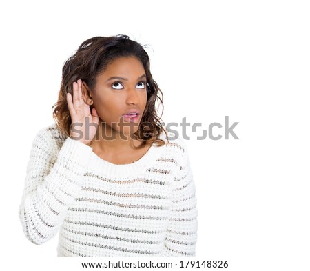 Closeup portrait of pretty, young, nosy woman, trying hard to secretly listen in on conversation, hand to ear, interested at juicy gossip she hears, privacy violation, isolated on white background