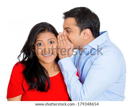 Closeup portrait of man whispering into woman\'s ear telling her something secret good news. Happy smiling cheerful toothy response. Positive communication human emotions facial expression feelings