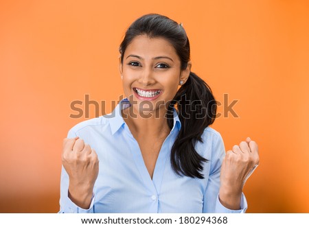 Closeup portrait of winning successful young business woman, happy ecstatic celebrating being winner, isolated on orange background. Positive human emotion facial expressions. Life achievement concept