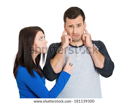 Closeup portrait of stressed young couple going through relationship hard times, isolated on white background. Upset angry sister, wife, girlfriend trying to explain something, annoyed man closes ears