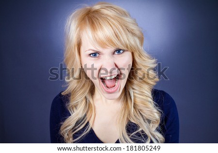 Closeup portrait angry, pissed off, upset, mad business woman, student screaming, fed up by boss, work life  isolated blue, black background. Negative human face expression, emotion, reaction attitude