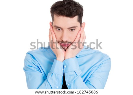 Closeup profile portrait of sad bothered stressed serious young man, hands on face, depressed about something or someone, isolated white background. Negative human emotion facial expression feeling