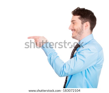 Closeup side view portrait of young man, laughing, pointing with finger at someone or something, isolated on white background. Positive human face expressions, emotions, feelings, attitude, approach