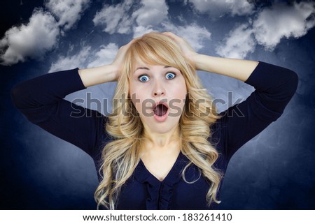 Closeup portrait, young, beautiful woman, looking excited, surprised in full disbelief, hands on head, isolated blue-gray background with white clouds. Emotions, facial expression, reaction, attitude