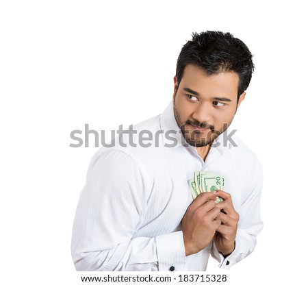 Closeup portrait greedy man corporate business employee, worker, student holding dollar banknotes tightly, isolated white background. Negative human emotion facial expression feeling