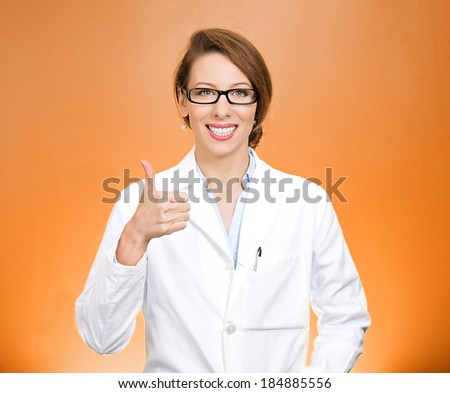 Closeup portrait, friendly, smiling, confident female, woman health care professional showing thumbs up sign gesture, isolated orange background. Patient visit. Positive face expression, attitude