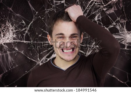 Closeup portrait, goofy, funny face, young man slapping hand on head to say duh, isolated brown background, shattered glass. Negative human emotion facial expression feelings, reaction, body language